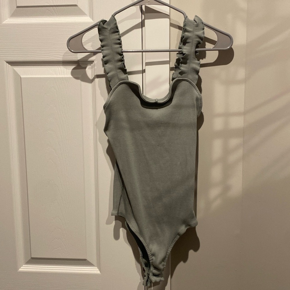 Light olive bodysuit with ruffle straps. Purchased at Francesca.